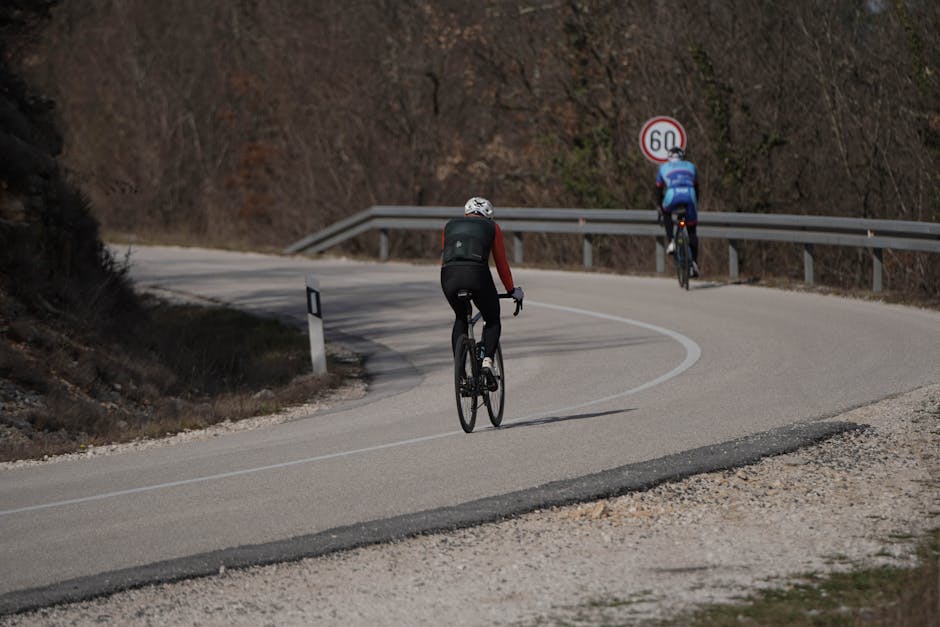 Cyclist packing bike into car trunk Balkan mountain road background