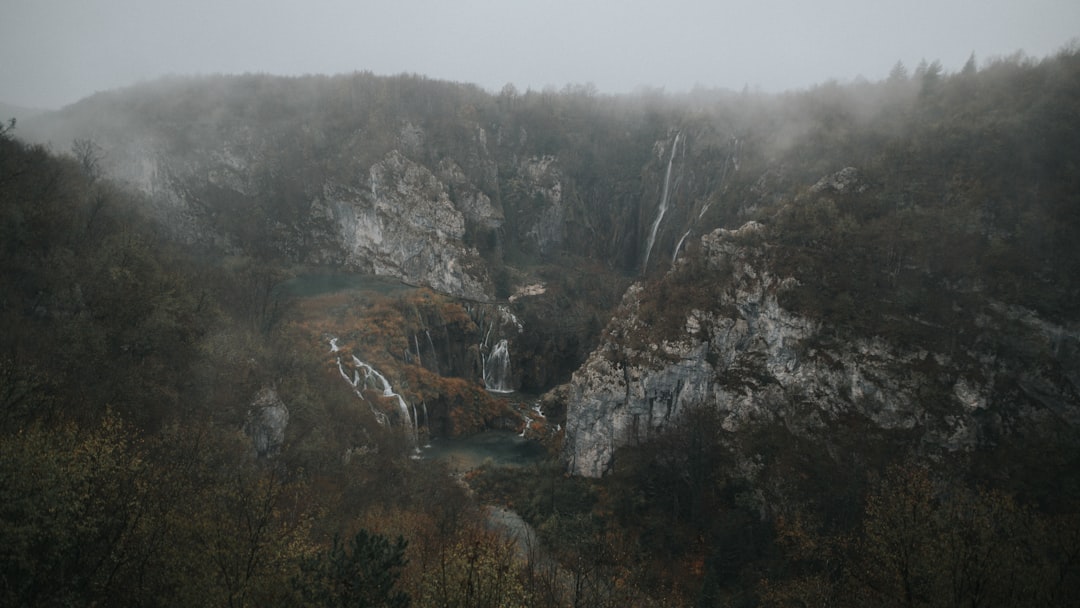 Veliki Slap waterfall Plitvice autumn fog misty forest