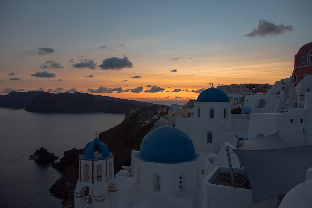 Oia Santorini blue domes sunset caldera view