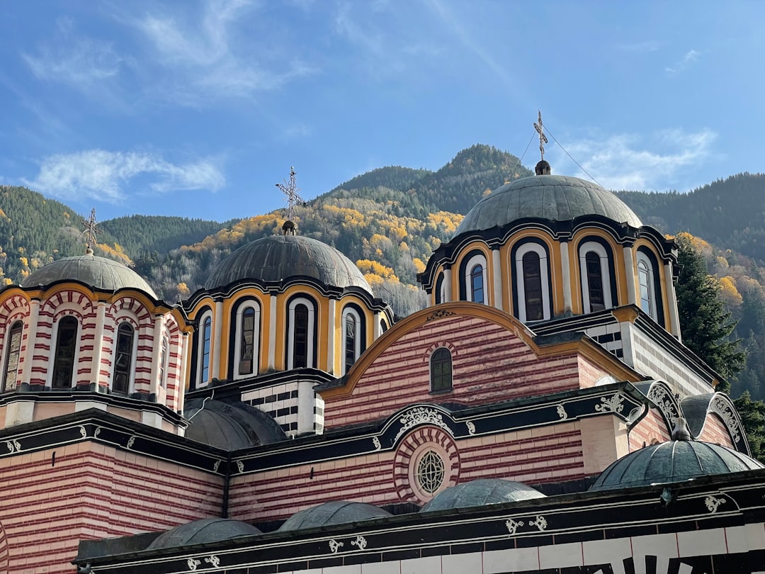 Rila Monastery Bulgaria fortified walls colorful facade mountain backdrop