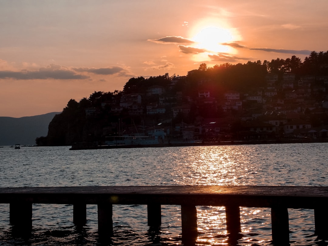 Cyclist resting on lakeside path Ohrid North Macedonia sunset