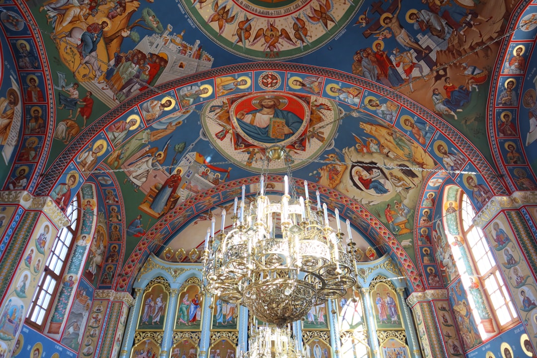 Moldovita Monastery exterior fresco biblical scenes vibrant colors Romania