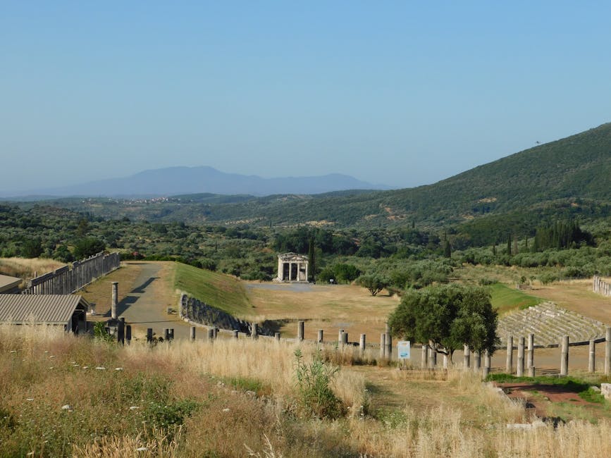 Cyclist riding through olive groves Peloponnese Greece ancient ruins background
